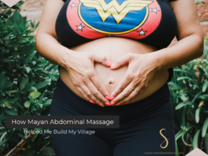Mayan Abdominal Massage image of a woman pregnant, hands on belly in heart shape.